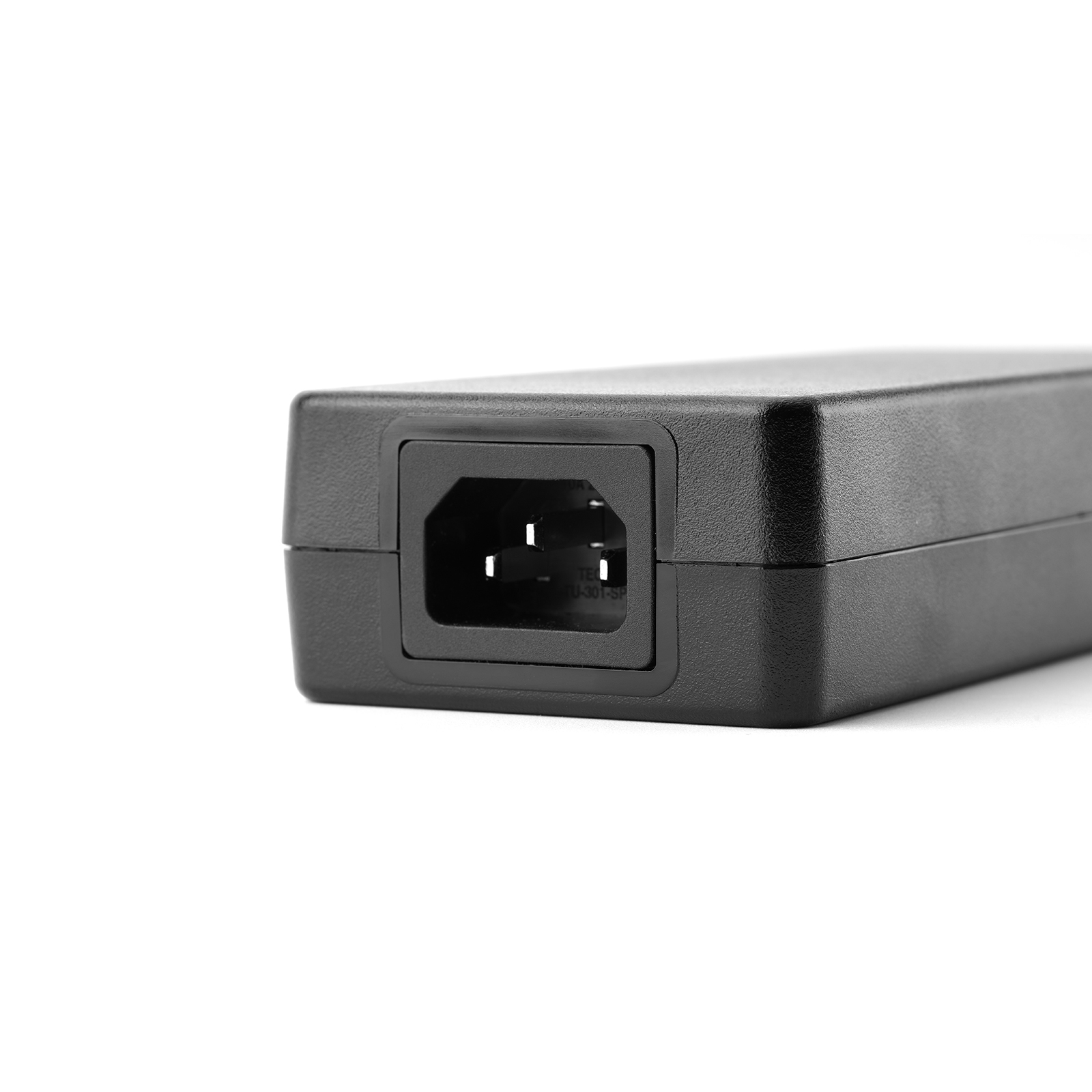 Close-up of AC input port on black power adapter